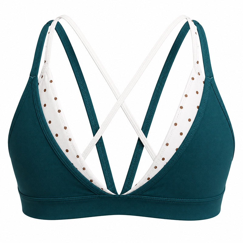 Women practicing yoga wearing custom polka dot cross-back sports bra