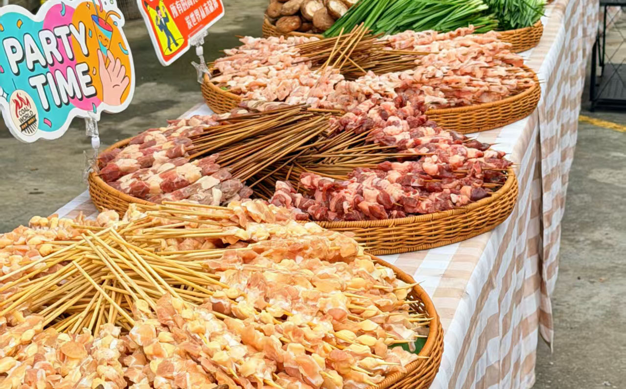 Bloomto colleagues preparing barbecue food and enjoying relaxed conversations during the annual team-building event.