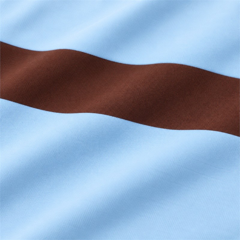 Close-up of the smooth blue and brown fabric surface on the color block yoga set