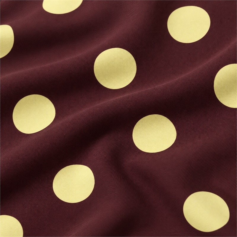 Pale yellow polka dots on the burgundy fabric of the mixed-print yoga set