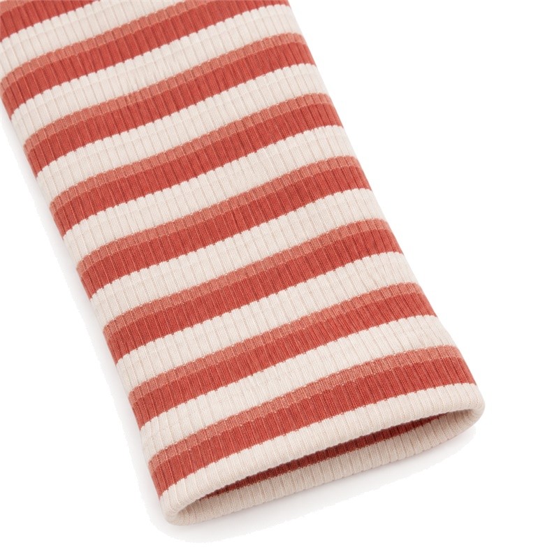 Finished sleeve cuff on the rust-red and cream striped yoga set jacket