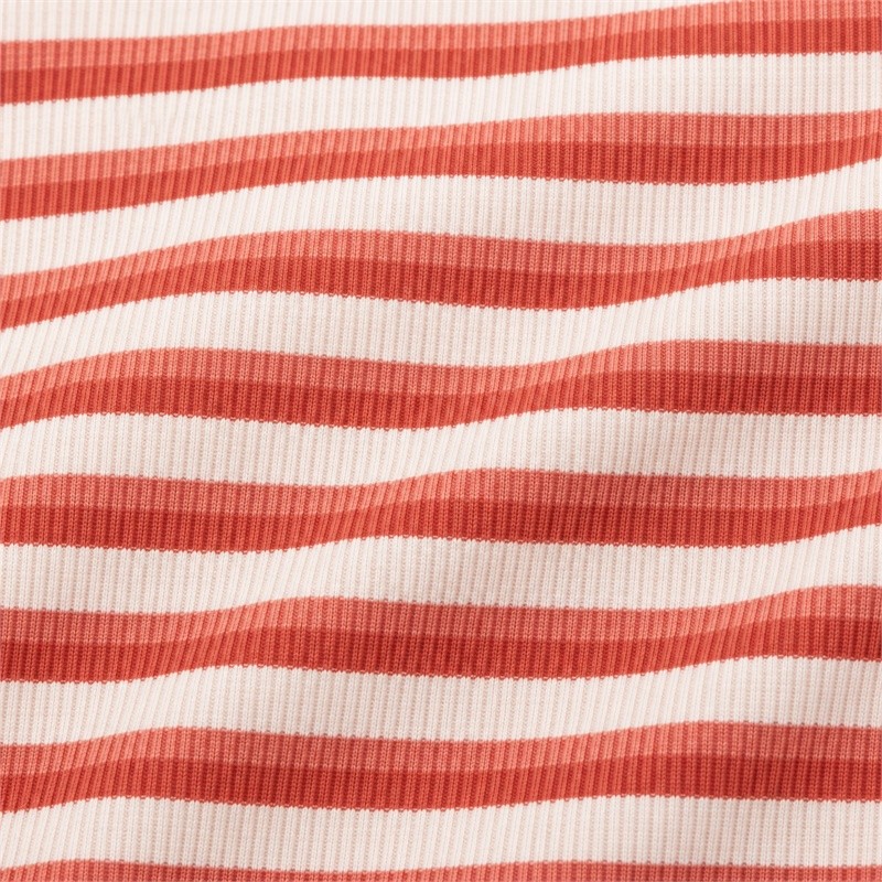 Fine vertical rib texture with rust-red and cream horizontal stripes on yoga set fabric