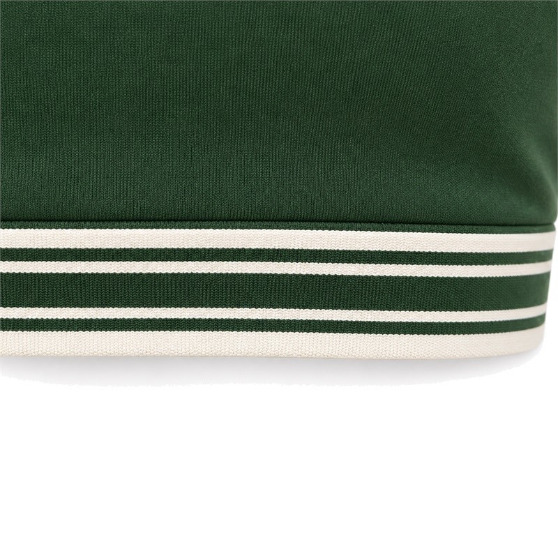 Layered sports bra striped lower band beneath a plain green front panel