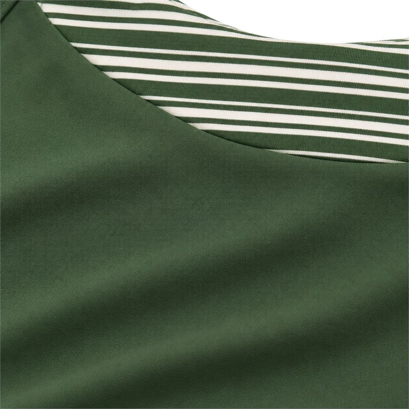 Layered sports bra fabric showing solid green surface and fine striped inset