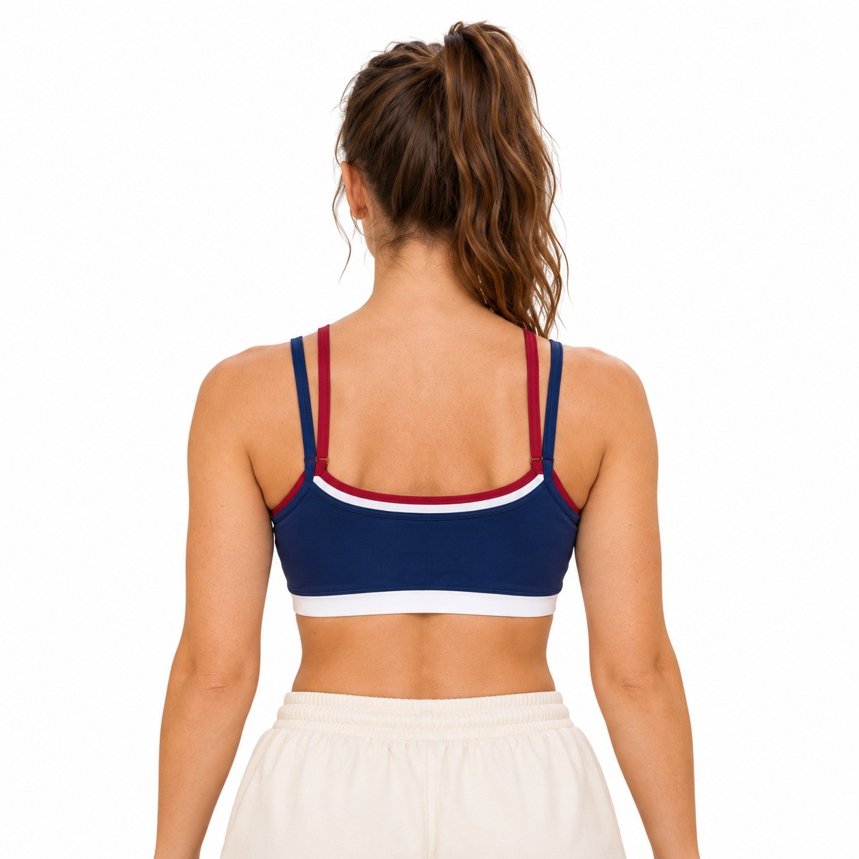 Back view of the navy yoga bra with double straps, contrast scoop-back trim and a flat white band