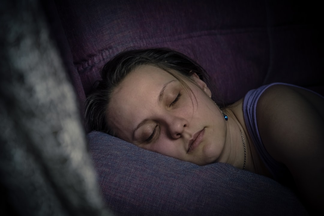 A person peacefully sleeping, with a sleep aid patch on their arm.
