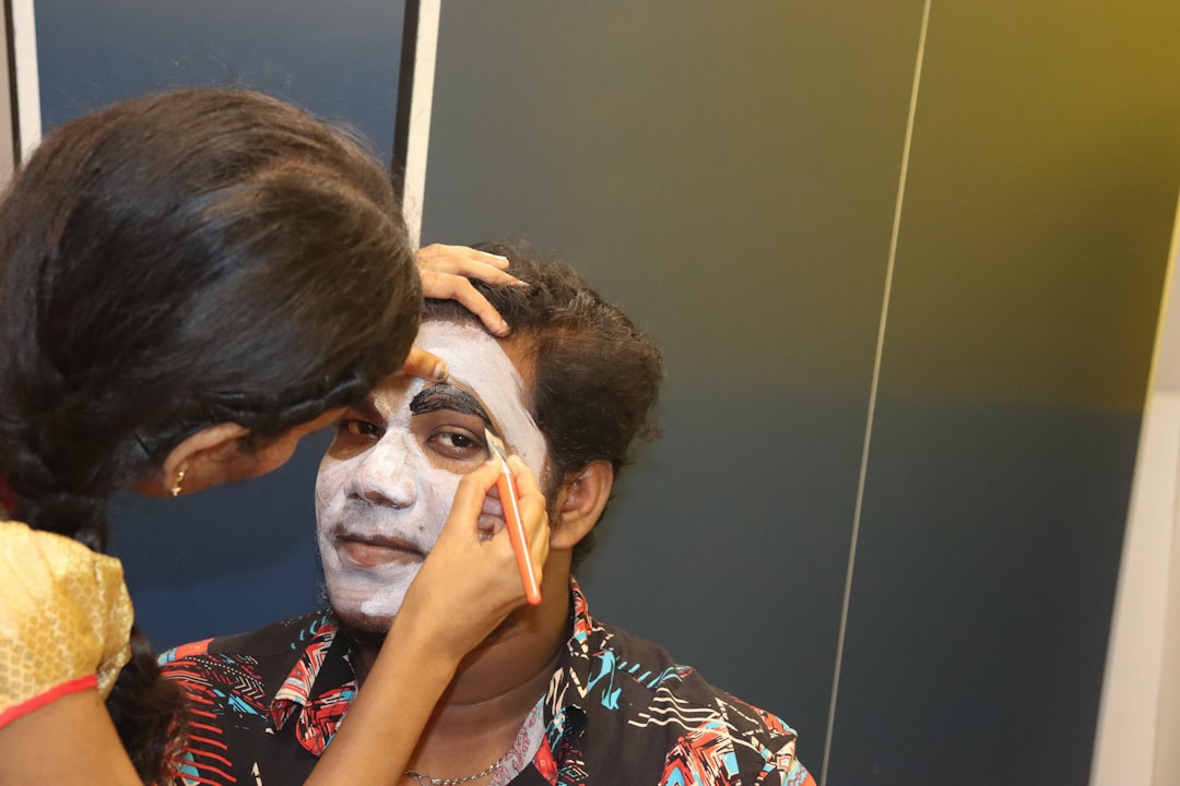 A person applying a daytime blemish patch to their cheek