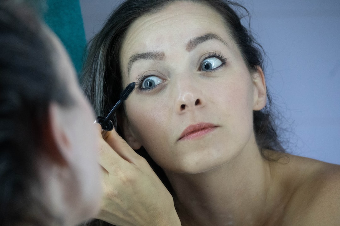 Woman applying a microdart patch to her face