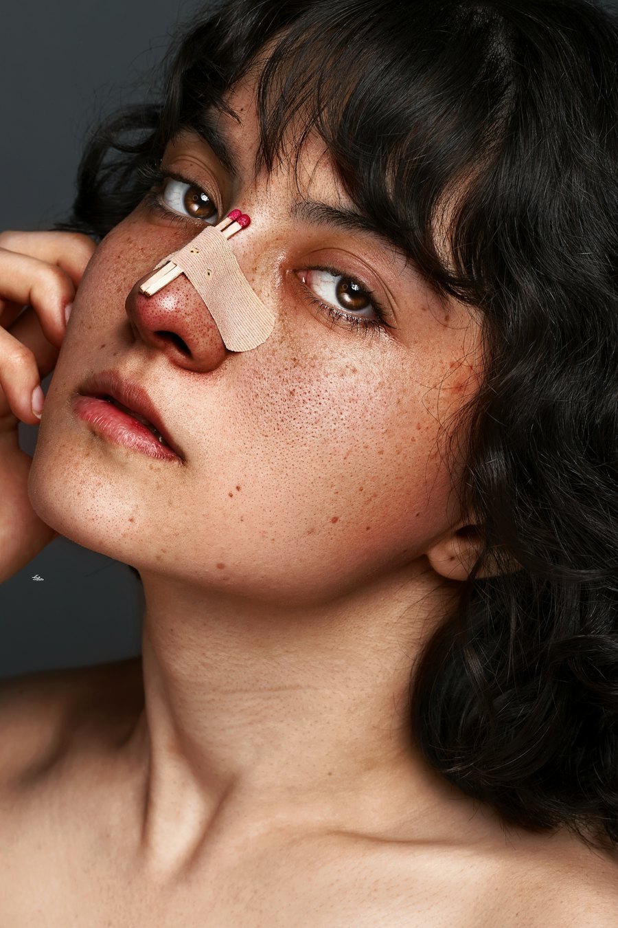 Young shopper friendly portrait wearing a small patch across the nose