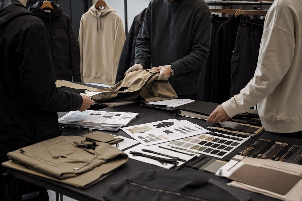 Apparel production transfer meeting in a modern garment factory sample room