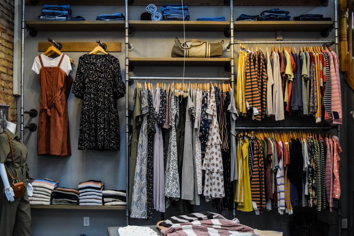 Fashion design workspace with tech packs, fabric swatches and production planning documents