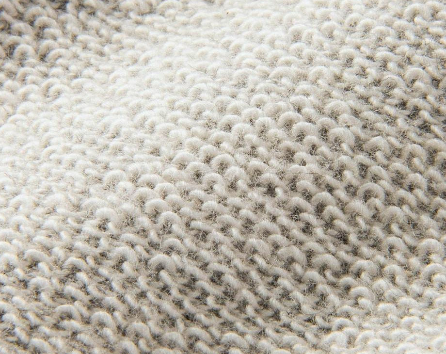 Close-up of unbrushed French terry fabric showing distinct cotton loopback yarns on the reverse side