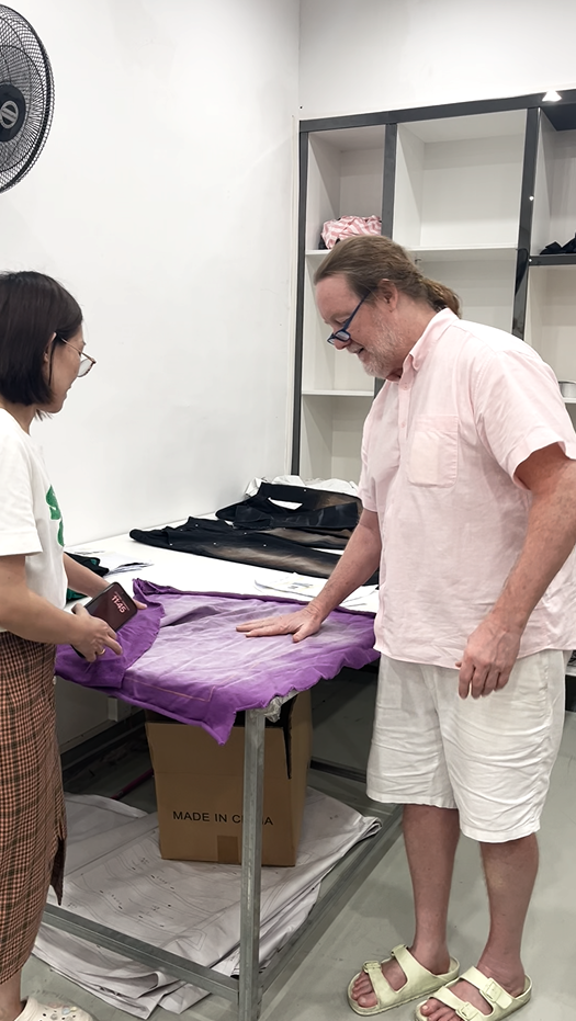 Evaluating garment wash effect and color fade on a purple sample during OEM/ODM development