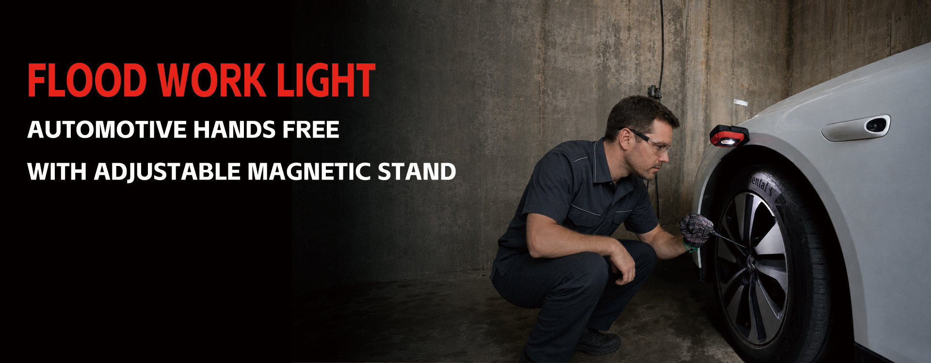 portable flood light with adjustable magnetic stand providing hands-free automotive lighting beside a car wheel