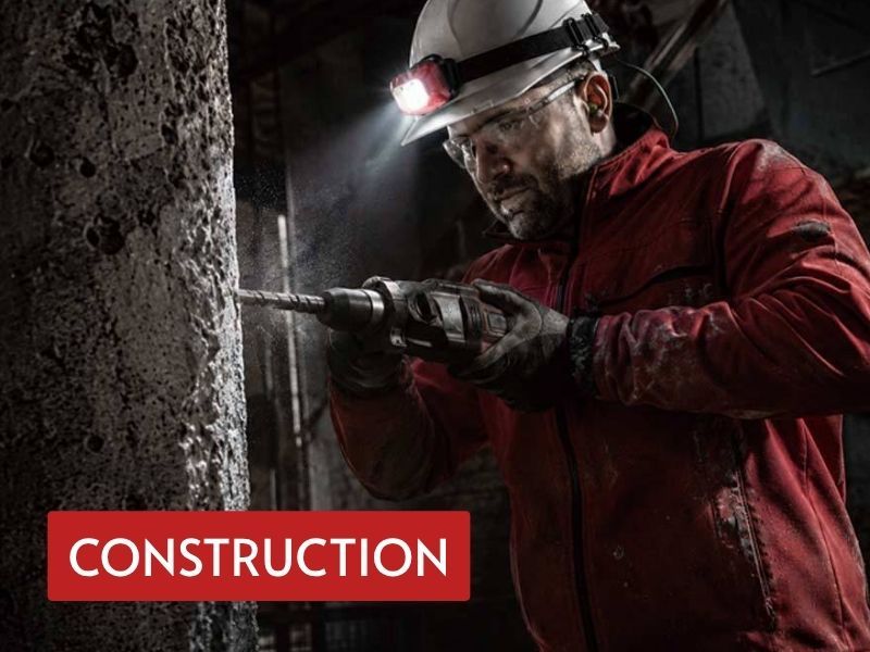 hard hat rechargeable light used during construction drilling in a low-light work area
