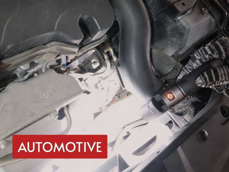 edc flashlight rechargeable model used for close automotive inspection around engine components