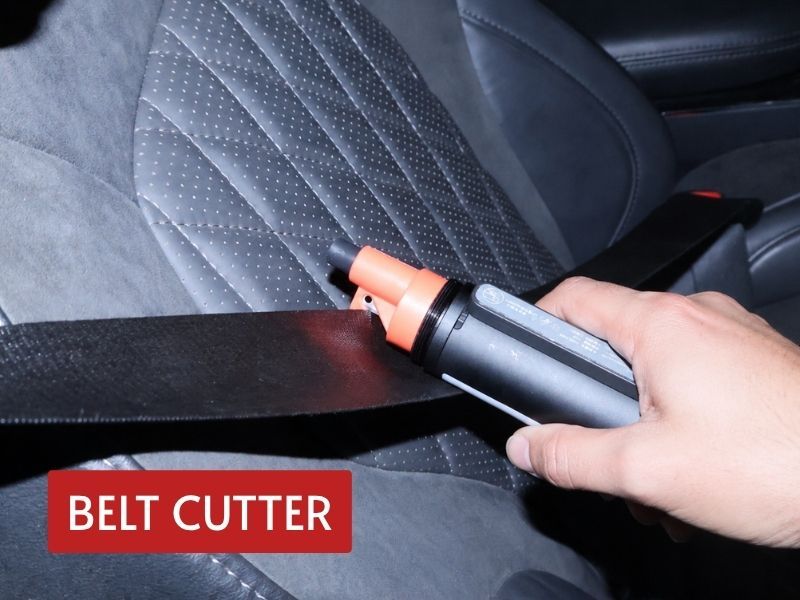 emergency flashlight with cutter used to slice a vehicle seat belt during an escape scenario