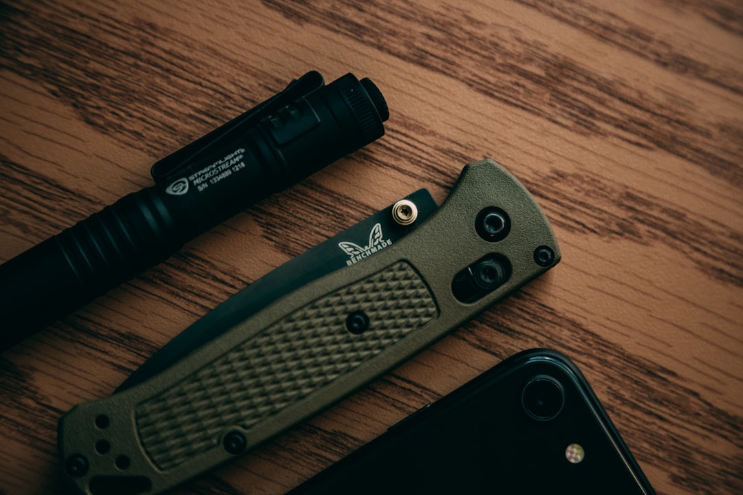 An EDC flashlight with an integrated green laser pointer being used for a presentation