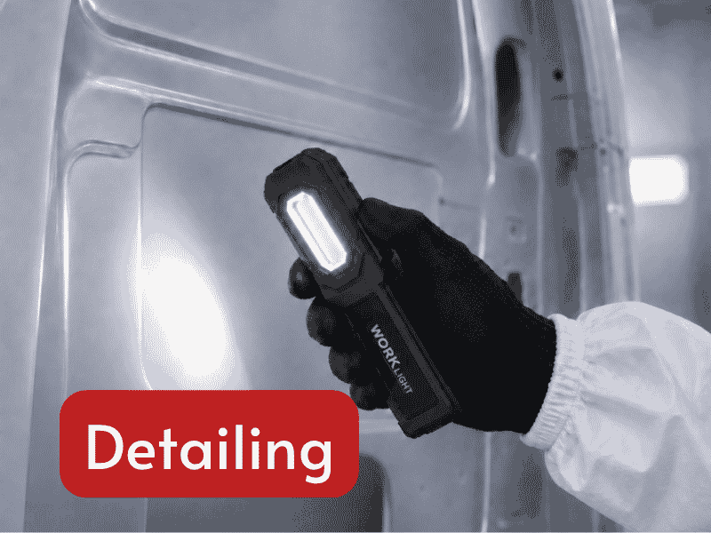 portable detailing inspection light illuminating vehicle surface during repair