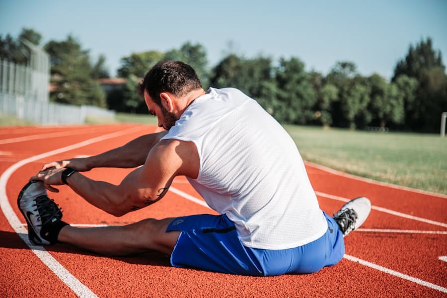 Athlete stretching on a running track during recovery