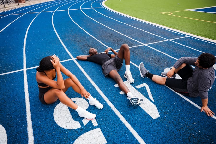 Athletes resting on a blue track after training
