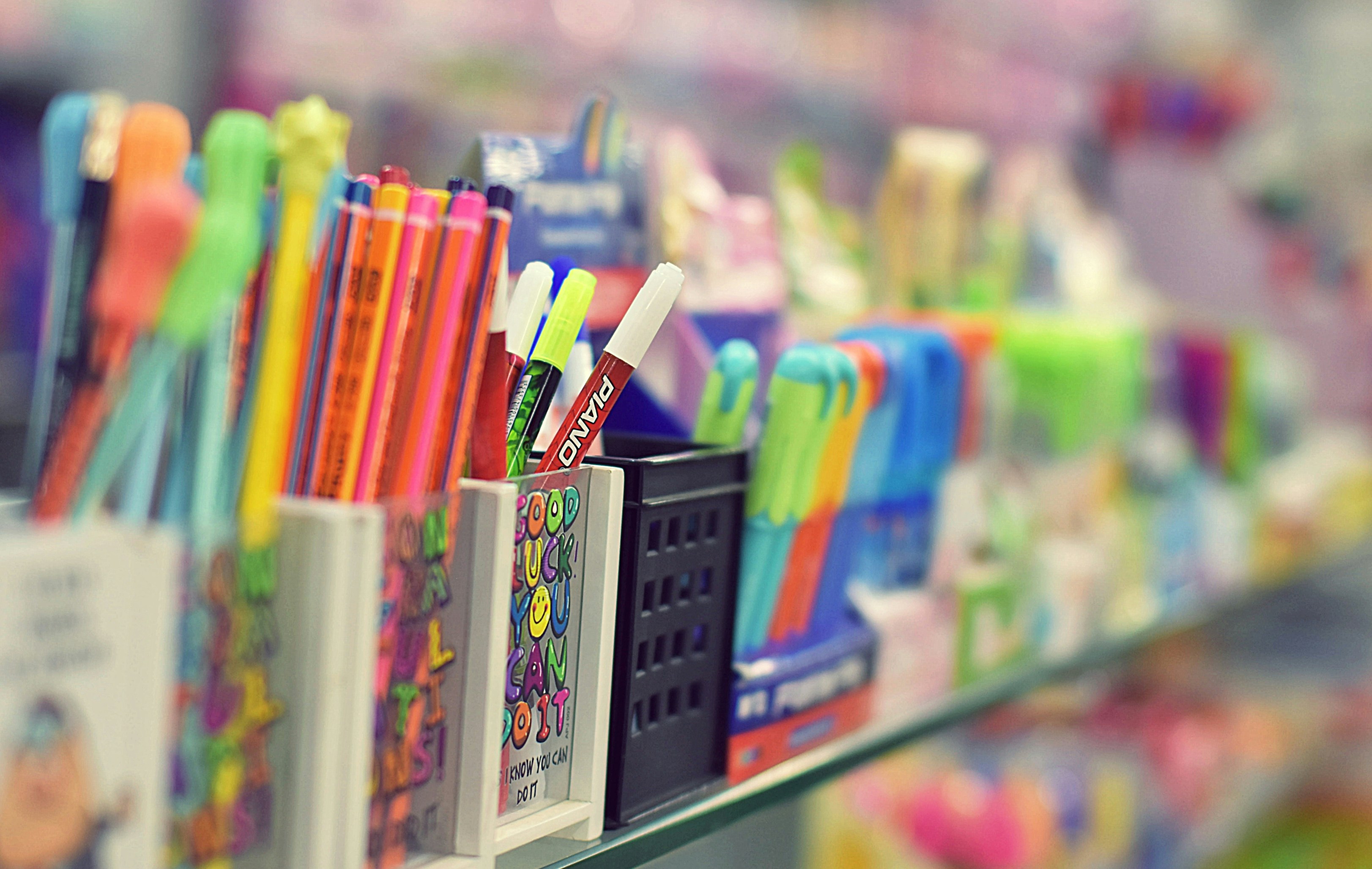 A neat row of sign holders displaying promotional information on a retail shelf.