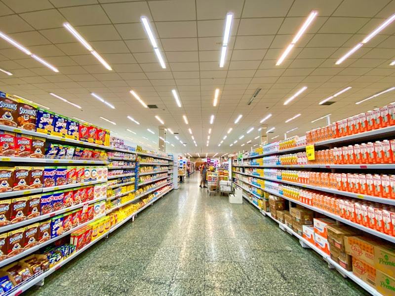 Retail employee stocking organized store shelves
