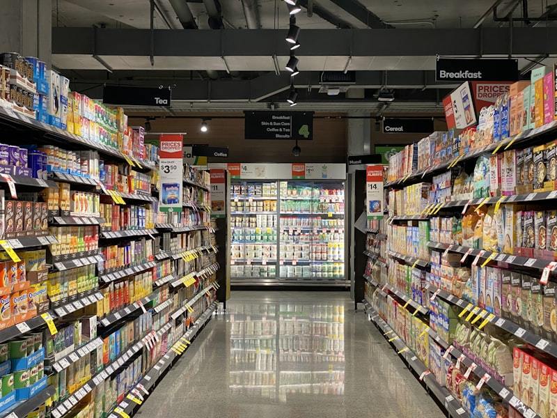 Modern supermarket aisle with well-organized shelving and product displays