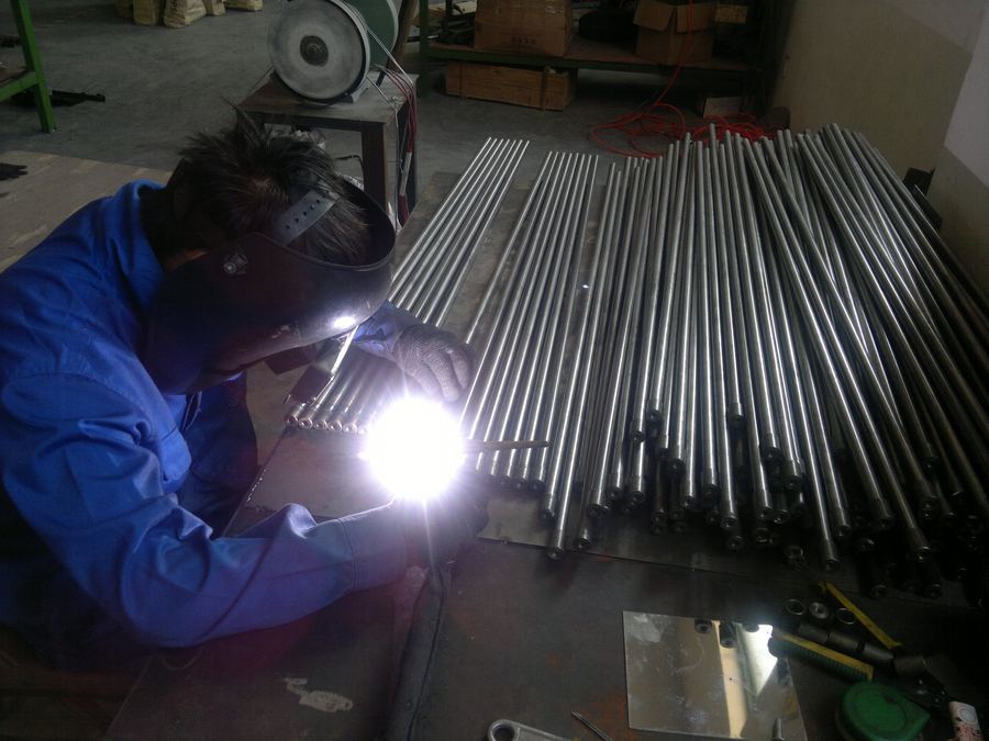 MIG welding of steel display frame tubes in a retail display factory