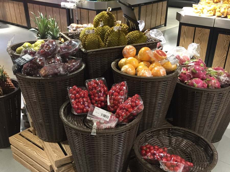 Wicker baskets on timber pallets in a supermarket fruit section