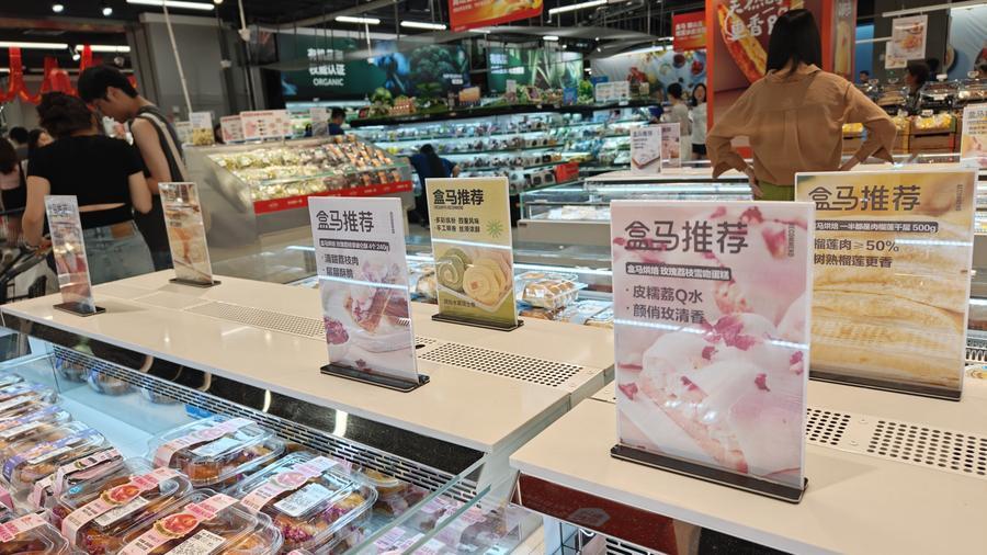 Metal-based sign holders with clear plastic sleeves on a retail counter