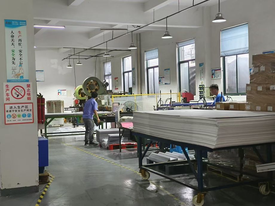 Incoming material inspection station at a display manufacturing factory, with raw components checked against specification before production