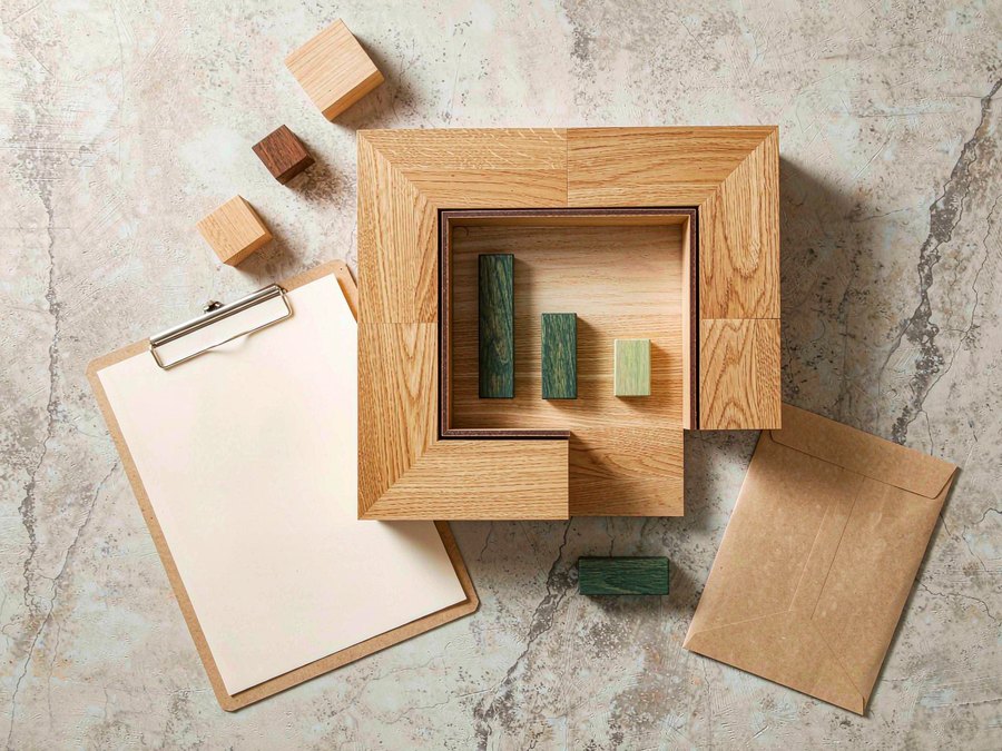 Illustrative flat lay of a timber sample, clipboard and document folder