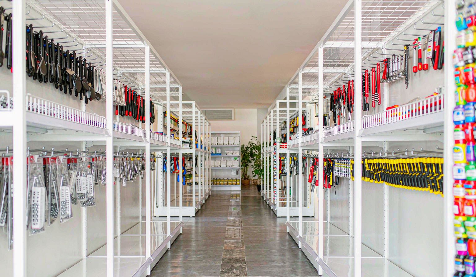 Supermarket aisle with merchandise hanging from hooks in tidy rows on shelving