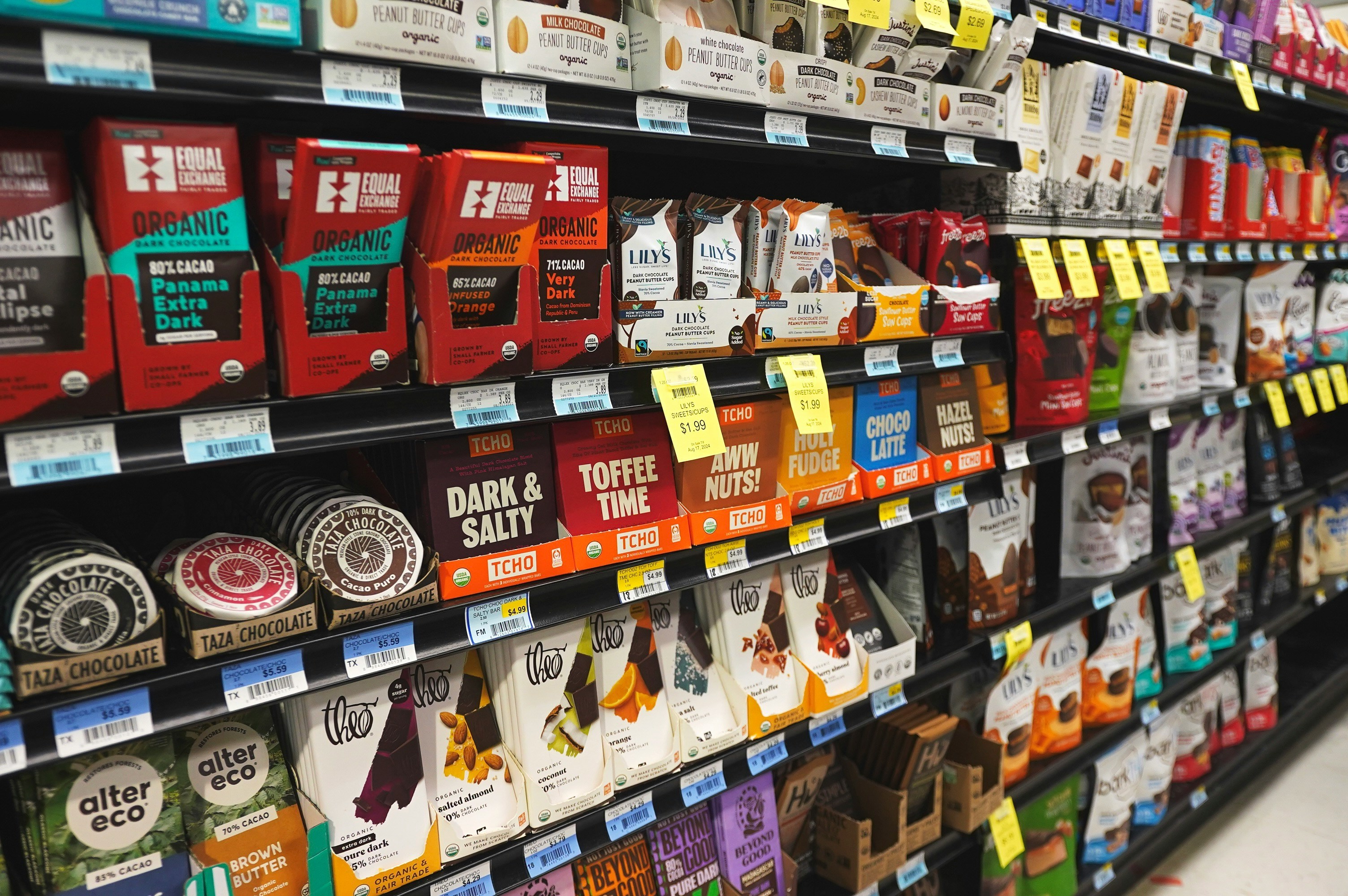 Fresh produce shelves with price strips running along the front edge of every tier
