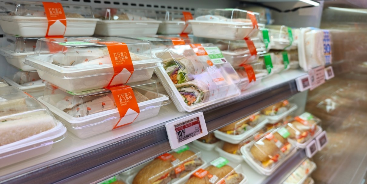 Refrigerated dairy case where pusher lanes keep the front row full between restocks