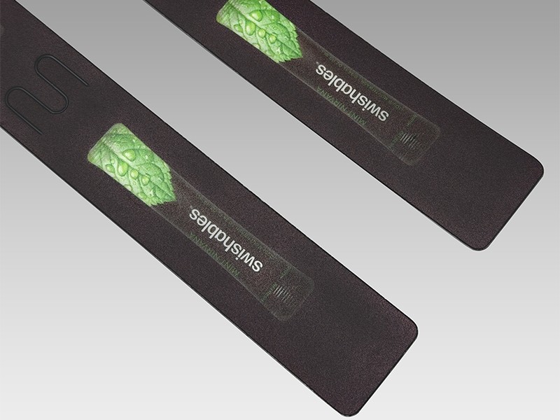 Two strips, three M-shaped slots each. The slots are cut straight into the printed face — no welded pocket, no adhesive, nothing for the store to assemble.