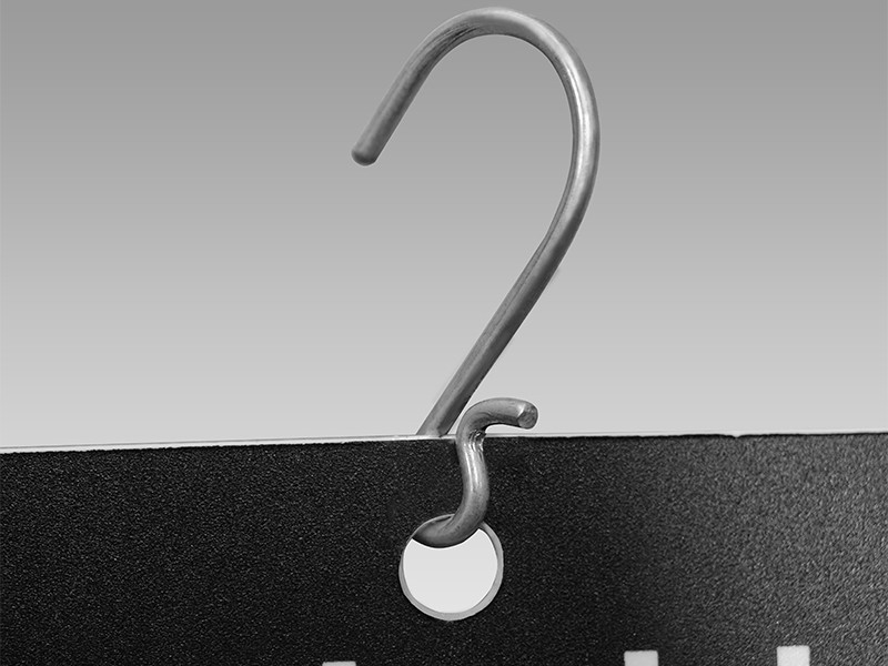 Metal hook through the header punch: free to rotate, so the strip self-levels on a pegboard hook or crossbar.