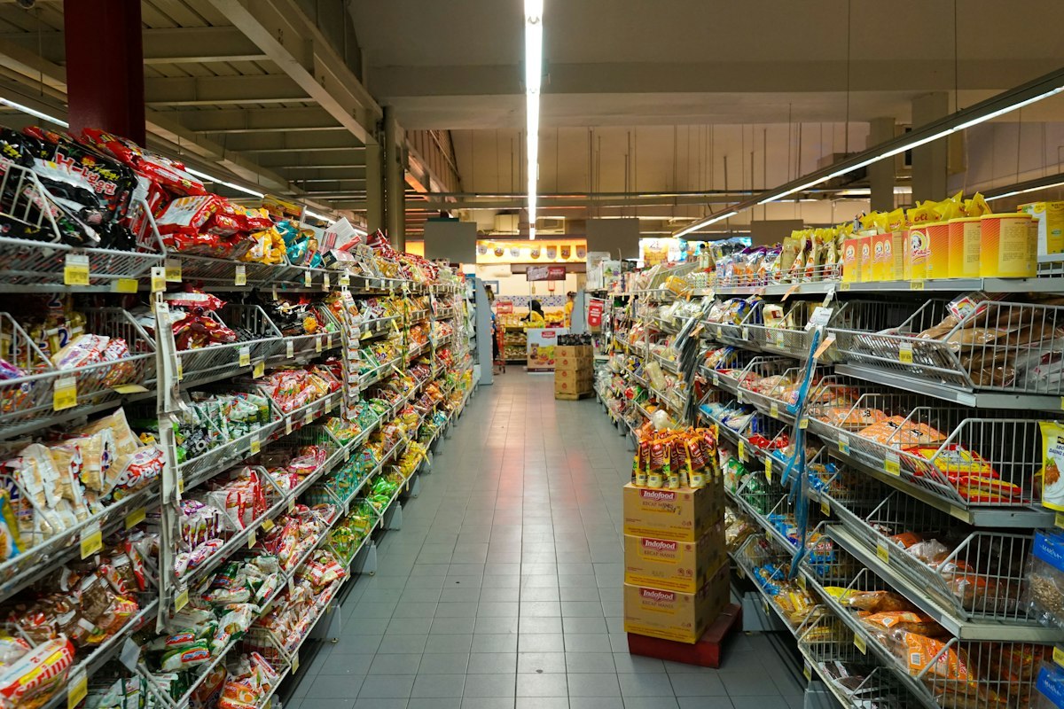 Snack aisle with wire shelving, bagged goods and shelf-edge label strips