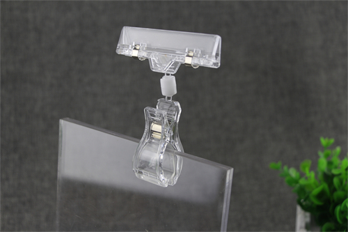 Transparent rotatable sign holder clip for retail display