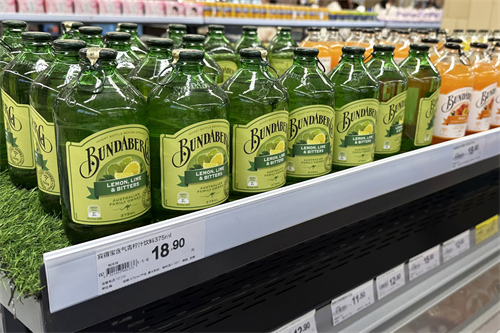 Retail shelf with liquid bottles and shelf label holders
