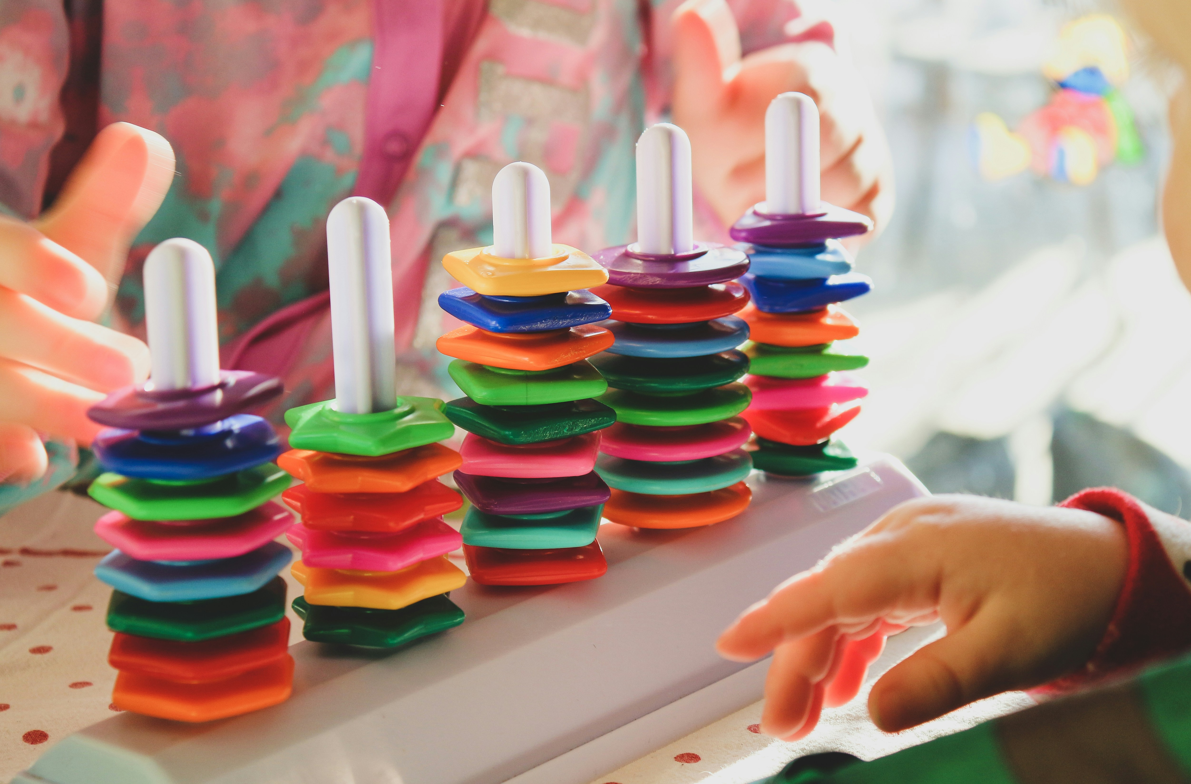 A child happily working on a colorful DIY craft kit at a table