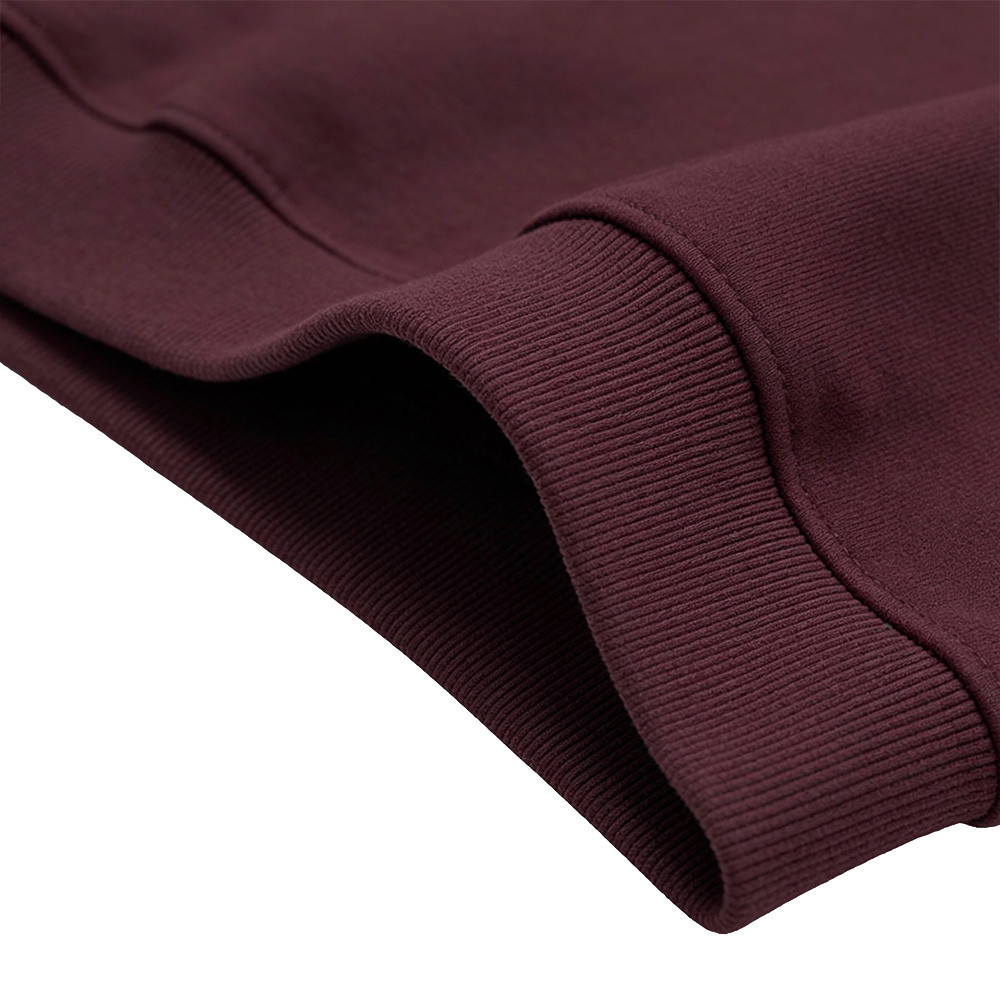 Burgundy ribbed hem detail showing fabric texture and stitching