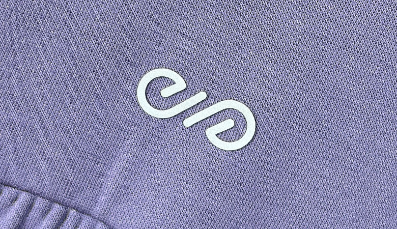 Custom private label heat transfer logo on purple ribbed activewear fabric
