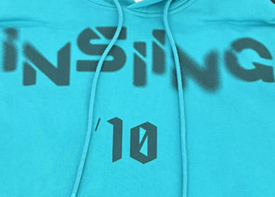 Vibrant silk screen printing on blue athletic hoodie showing durable eco-friendly ink application.