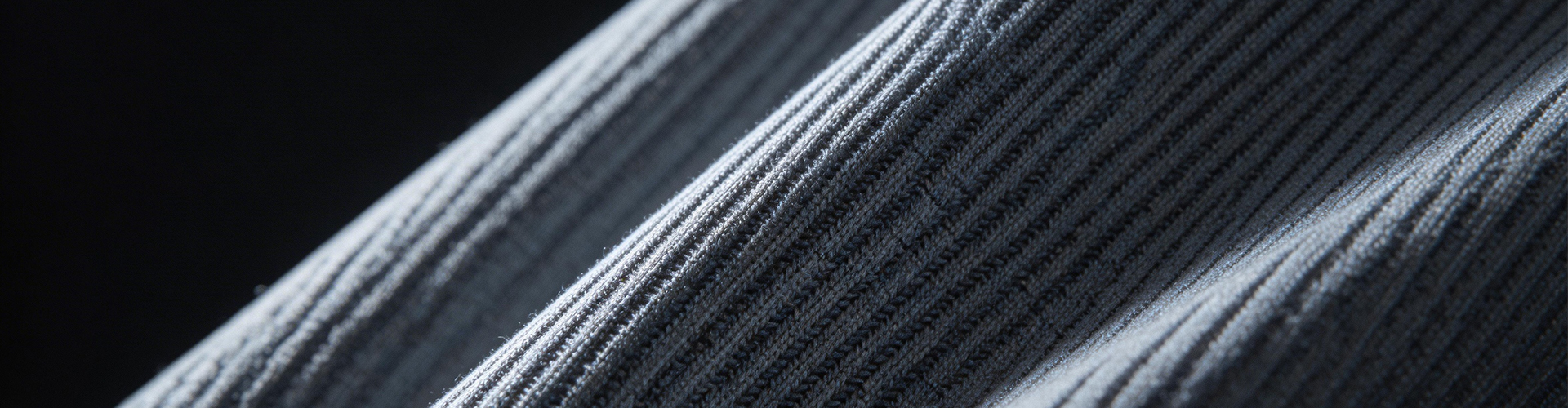 Macro texture shot of premium ribbed activewear fabric with 4-way stretch and moisture-wicking technology for yoga and sportswear manufacturing.