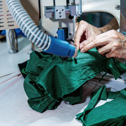 Close-up of garment assembly in our BSCI-audited facility for custom eco-friendly sportswear manufacturing.