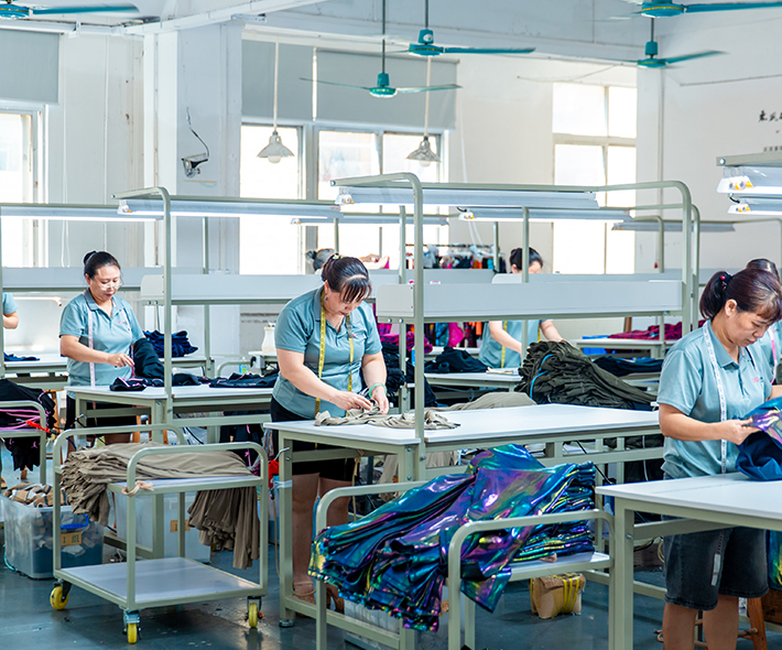 Skilled female worker in our BSCI-audited and ethical activewear manufacturing facility.