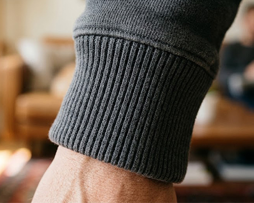 Organic cotton grey rib-knit cuff detail for eco-friendly custom hoodies and streetwear private label manufacturing.