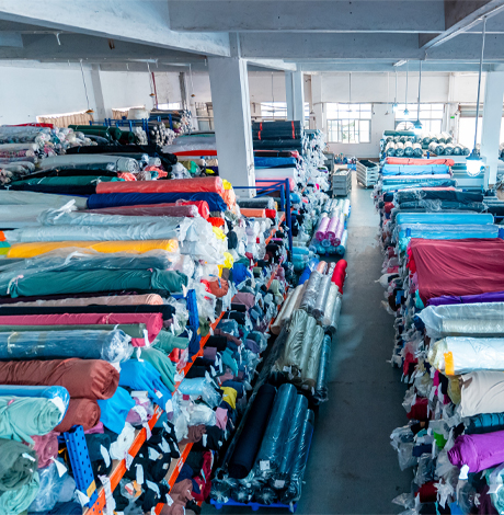 Massive fabric warehouse showing premium material sourcing capabilities for custom activewear manufacturing.